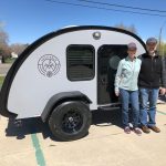 Couple standing next to their Bean Trailer