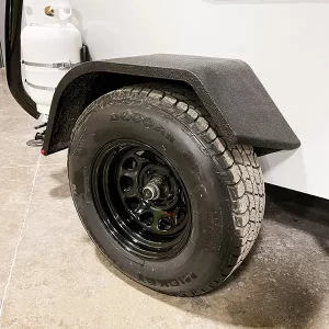 Fiberglass stand-on fender with 15" wheel and all-terrain tire.