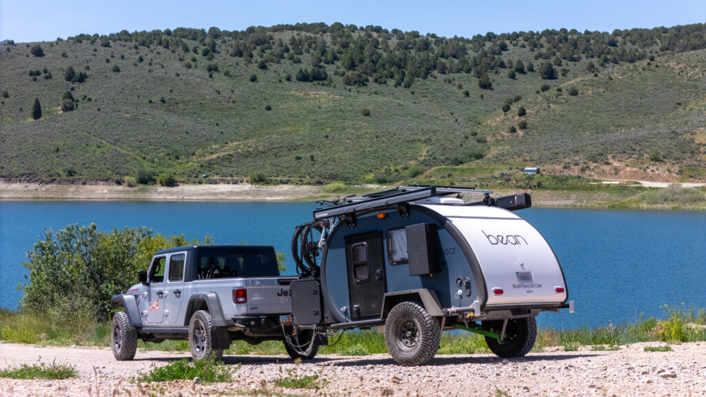 Meaner Bean hitched to a Jeep beside a lake