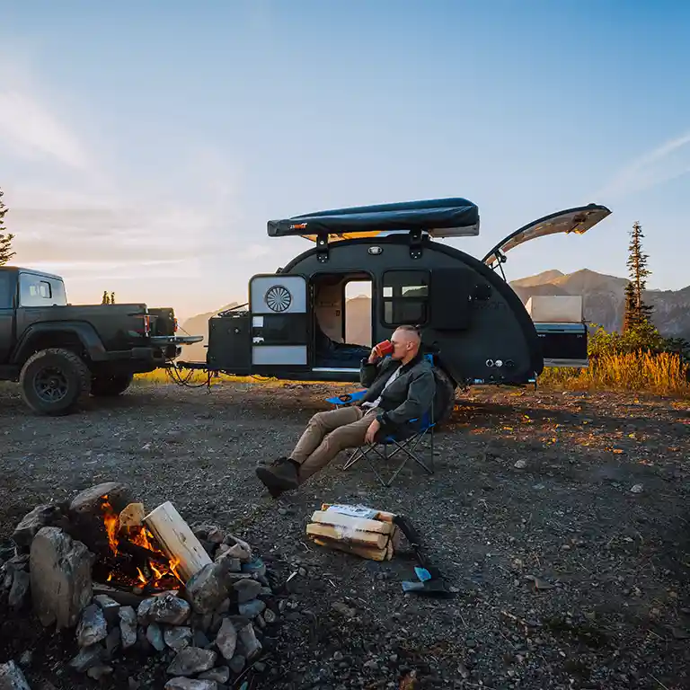 Black Bean at camp beside a fire at dusk
