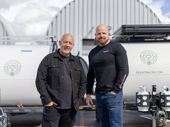 Bean Trailer founders Mark and Brian in front of two finished trailers