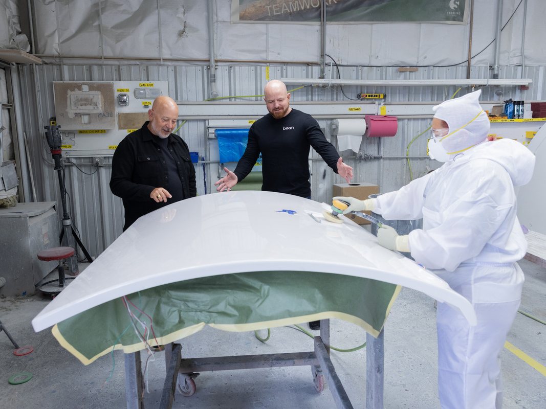 Mark and Brian with a technician finishing a one-piece fiberglass shell
