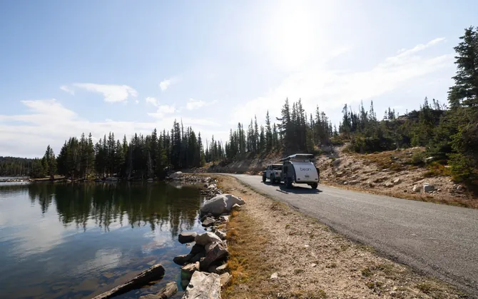 A Bean towed along the shore of an alpine lake