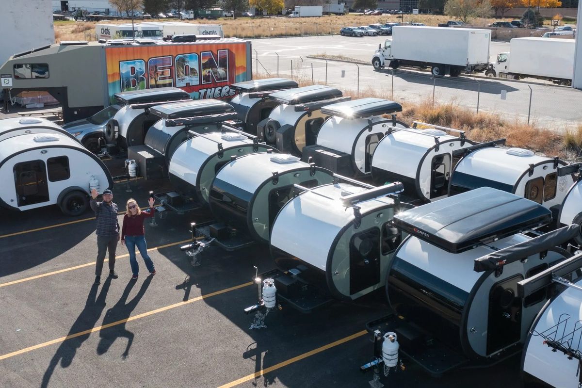 A long row of finished Bean trailers lined up on the lot
