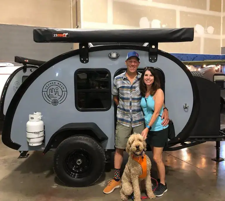 Meaner Bean owners and their dog beside their trailer